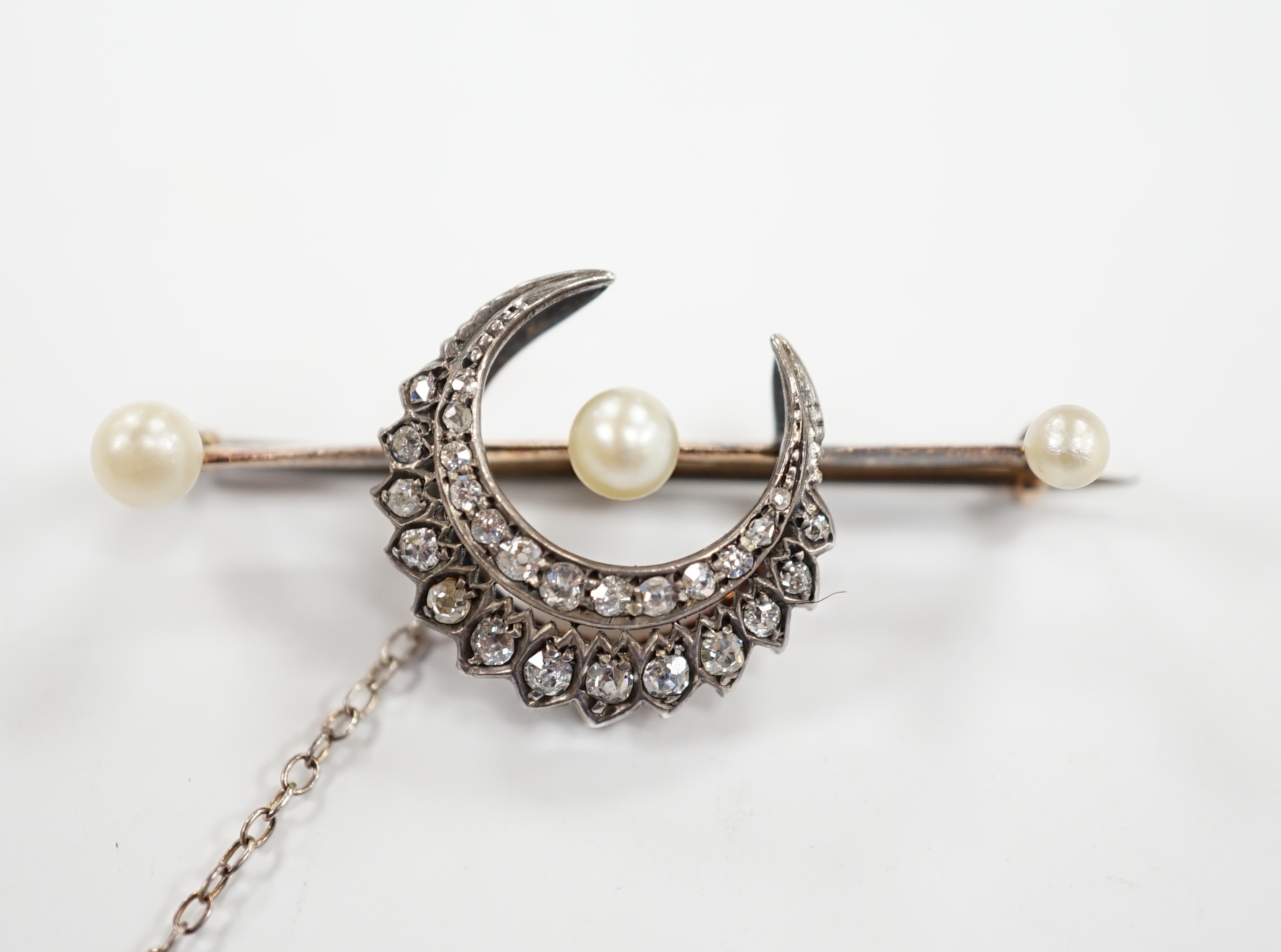 A Victorian yellow and white metal, diamond and pearl set crescent bar brooch, 44mm, gross weight 6.1 grams.